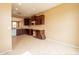 Expansive kitchen features dark wood cabinets, tile countertops, and an eat in area at 4432 W Pleasant Ln, Laveen, AZ 85339