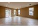 Spacious living room with tile flooring, recessed lighting, and sliding glass door to back patio at 4432 W Pleasant Ln, Laveen, AZ 85339