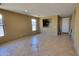 Open living room with tile floors, natural light and tan colored walls at 4432 W Pleasant Ln, Laveen, AZ 85339