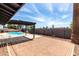 Backyard featuring a refreshing pool, brick patio, and a shaded pergola at 4510 N 105Th Ave, Phoenix, AZ 85037