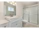 Well-lit bathroom with a glass shower door and a white vanity at 4510 N 105Th Ave, Phoenix, AZ 85037