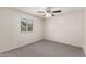 Bedroom featuring neutral walls, carpeting, a window, and ceiling fan at 4510 N 105Th Ave, Phoenix, AZ 85037