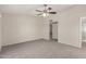Spacious bedroom with access to bathroom, carpeted floors, and ceiling fan at 4510 N 105Th Ave, Phoenix, AZ 85037