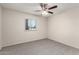 Carpeted bedroom featuring a ceiling fan and a window at 4510 N 105Th Ave, Phoenix, AZ 85037