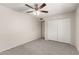 Neutral bedroom featuring a ceiling fan and a closet with sliding doors at 4510 N 105Th Ave, Phoenix, AZ 85037