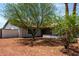 Attractive single-story home featuring desert landscaping and mature trees for shade at 4510 N 105Th Ave, Phoenix, AZ 85037