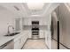 Bright kitchen featuring stainless steel appliances, tile floors, and white cabinetry at 4510 N 105Th Ave, Phoenix, AZ 85037
