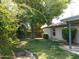 Fenced-in backyard with green grass and shade trees at 4513 E Grovers Ave, Phoenix, AZ 85032