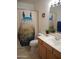 Bathroom with decorative shower curtain, toilet, sink, and mirror at 4513 E Grovers Ave, Phoenix, AZ 85032