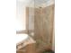 Bathroom featuring a soaking tub and glass-enclosed shower with decorative tile at 4513 E Grovers Ave, Phoenix, AZ 85032