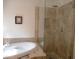 Bathroom showcases a soaking tub and glass-enclosed shower with decorative tile at 4513 E Grovers Ave, Phoenix, AZ 85032