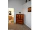 Bedroom with an antique armoire and a bathroom in the background at 4513 E Grovers Ave, Phoenix, AZ 85032