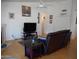 Cozy living room with a leather couch, TV, ceiling fan and neutral decor at 4513 E Grovers Ave, Phoenix, AZ 85032