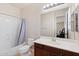 Bathroom featuring a shower-tub combo, light tile floors and a dark wood vanity and single sink at 4517 W Lodge Dr, Laveen, AZ 85339