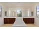 This luxurious bathroom boasts dual sinks, a soaking tub, and bright natural light at 4517 W Lodge Dr, Laveen, AZ 85339