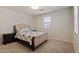 Neutral bedroom featuring carpet floors, a tufted headboard and side tables and a window at 4517 W Lodge Dr, Laveen, AZ 85339