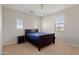 Simple bedroom featuring carpet floors, a blue bedspread, a dark wood nightstand and three windows at 4517 W Lodge Dr, Laveen, AZ 85339