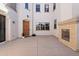 Inviting courtyard entrance with a wooden door, fireplace, and neutral color palette for an open feel at 4517 W Lodge Dr, Laveen, AZ 85339