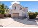 Spacious home with a large garage, arched entryways, and a well-maintained driveway, suitable for multiple vehicles at 4517 W Lodge Dr, Laveen, AZ 85339