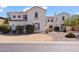 Elegant stucco home with a tile roof, a well-manicured yard, and a welcoming facade at 4517 W Lodge Dr, Laveen, AZ 85339