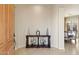 Warm foyer featuring a wooden console table with decorative accents and views into the dining room at 4517 W Lodge Dr, Laveen, AZ 85339