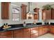 Kitchen with granite countertops, stainless steel range hood, and custom wood cabinets at 4517 W Lodge Dr, Laveen, AZ 85339
