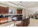 Spacious kitchen with dark wood cabinets, a center island, and a seamless flow to dining area at 4517 W Lodge Dr, Laveen, AZ 85339