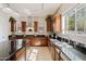 Well-lit kitchen with dark cabinetry, stainless steel appliances, and a functional layout for cooking at 4517 W Lodge Dr, Laveen, AZ 85339