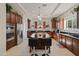 Gourmet kitchen with dark wood cabinets, stainless steel appliances, and a large center island with seating at 4517 W Lodge Dr, Laveen, AZ 85339