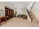 Cozy living room with a built-in bookshelf, a comfortable leather sofa, and a staircase with iron railings at 4517 W Lodge Dr, Laveen, AZ 85339