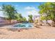 Backyard view featuring a stunning pool and spa, surrounded by lush landscaping, perfect for relaxation at 4517 W Lodge Dr, Laveen, AZ 85339