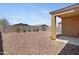 Gravel backyard featuring a covered patio and block wall fencing provides a serene outdoor space at 4628 W Greenleaf Dr, San Tan Valley, AZ 85144