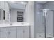 Bathroom featuring a walk-in shower, double sink vanity with large mirror at 4628 W Greenleaf Dr, San Tan Valley, AZ 85144