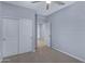 Bedroom with carpet, closet, and open door with a ceiling fan at 4628 W Greenleaf Dr, San Tan Valley, AZ 85144