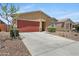 Inviting single-story home with a spacious driveway and desert-style landscaping at 4628 W Greenleaf Dr, San Tan Valley, AZ 85144