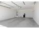 Spacious garage with concrete floors, water heater, and water softener at 4628 W Greenleaf Dr, San Tan Valley, AZ 85144
