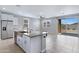 Open kitchen with a large island, modern appliances, and sliding glass doors to the backyard at 4628 W Greenleaf Dr, San Tan Valley, AZ 85144