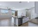 Open concept living area featuring tile floors, a ceiling fan, a kitchen island and stainless steel dishwasher at 4628 W Greenleaf Dr, San Tan Valley, AZ 85144
