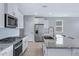 Bright kitchen with stainless steel appliances, a stylish backsplash, and a large center island at 4628 W Greenleaf Dr, San Tan Valley, AZ 85144