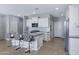 Bright kitchen boasts granite countertops, stainless appliances, tiled backsplash and island with breakfast bar seating at 4628 W Greenleaf Dr, San Tan Valley, AZ 85144