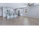 Spacious living area with tile floors, kitchen with granite countertops, island with barstools, and stainless steel appliances at 4628 W Greenleaf Dr, San Tan Valley, AZ 85144