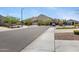 Street view showing well-maintained homes, desert landscaping, and mountain backdrop enhancing community charm at 4628 W Greenleaf Dr, San Tan Valley, AZ 85144