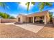 An open backyard features desert landscaping, mature trees, and a covered patio, perfect for entertaining at 4639 E Cabrillo Dr, Gilbert, AZ 85297