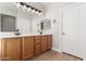 Bright bathroom with double sinks, wood cabinets, and modern lighting, offering plenty of counter space at 4639 E Cabrillo Dr, Gilbert, AZ 85297