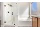 Well-lit bathroom with a glass shower enclosure and a separate soaking tub with modern fixtures and cabinets at 4639 E Cabrillo Dr, Gilbert, AZ 85297
