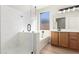 Stylish bathroom featuring a glass-enclosed shower, a soaking tub, and wood cabinets with a large mirror at 4639 E Cabrillo Dr, Gilbert, AZ 85297