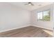 Well-lit bedroom features wood flooring and a large window offering views of the outdoors at 4639 E Cabrillo Dr, Gilbert, AZ 85297
