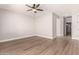 A spacious bedroom featuring light hardwood floors, a ceiling fan, and neutral walls at 4639 E Cabrillo Dr, Gilbert, AZ 85297