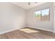 Bright bedroom with modern light fixture, neutral walls, and a window overlooking the backyard at 4639 E Cabrillo Dr, Gilbert, AZ 85297