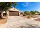 Charming single-story home with a brown two car garage, desert landscaping and a walkway to the front door at 4639 E Cabrillo Dr, Gilbert, AZ 85297